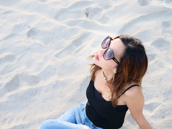 High angle view of woman sitting on beach