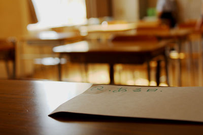 Close-up of paper on desk in classroom