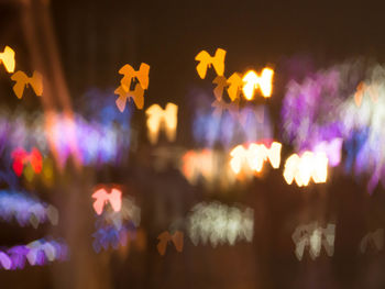 Defocused image of illuminated christmas lights at night