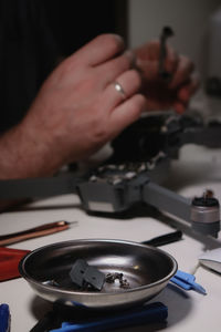 Cropped hand of man using laptop