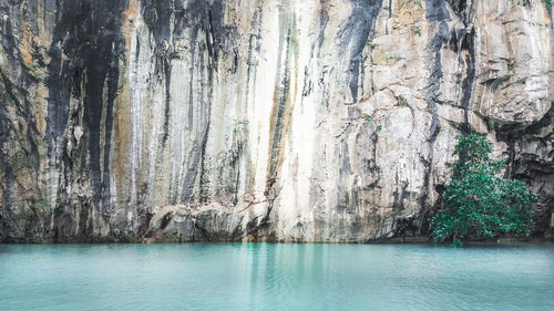 Scenic view of sea against rock formation