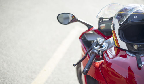 High angle view of helmet over motorcycle on road