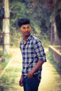 Portrait of young man standing outdoors