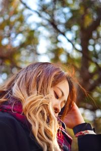 Low angle view of woman against trees