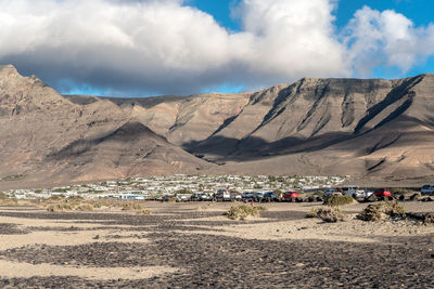 Panoramic view of land and mountains against sky