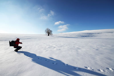 Scenic view of snowy field against sky