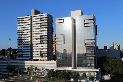 Low angle view of buildings against blue sky