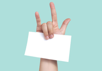 Low angle view of human hand against white background