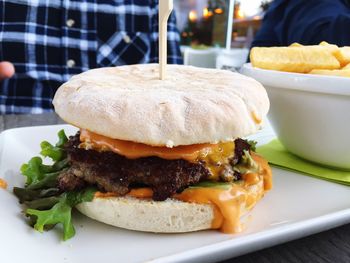 Close-up of hamburger served in plate on table at restaurant