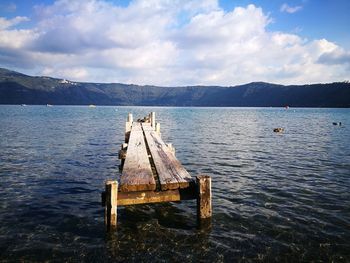 Pier over lake against sky