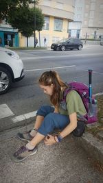 Full length of woman on road in city