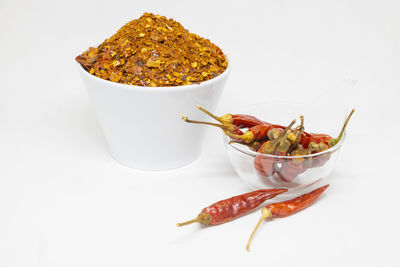 Close-up of chili peppers on white background