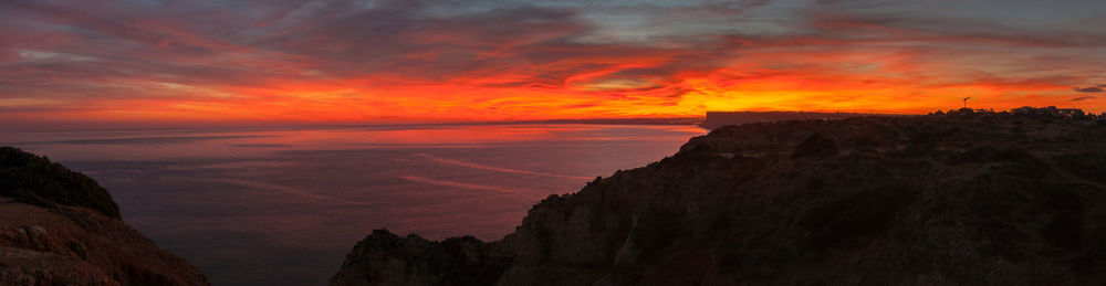 Scenic view of dramatic sky over sea during sunset