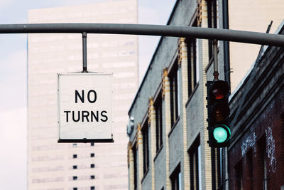 No turns traffic sign and green traffic light, urban scene