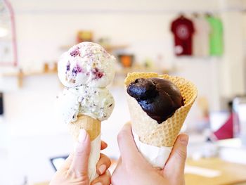 Close-up of hand holding ice cream cone