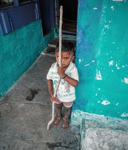 High angle view of girl standing against wall