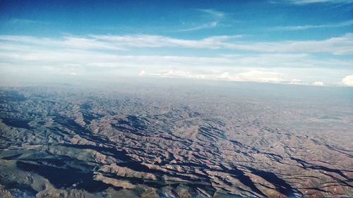 Aerial view of landscape against cloudy sky