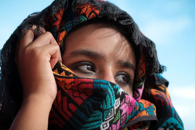 Close-up portrait of woman with snow covered face