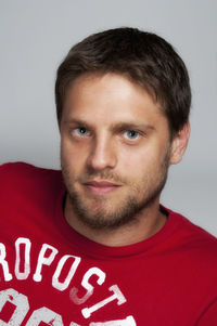 Portrait of smiling young man against white background