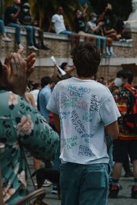 Rear view of people standing on street