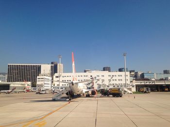 View of buildings against clear blue sky