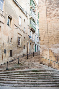 Low angle view steps by buildings