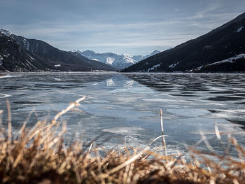 Scenic view of lake against sky during winter