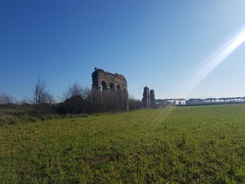 Castle on field against clear sky