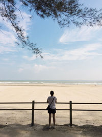 Girl standing look at the beach and blue sky