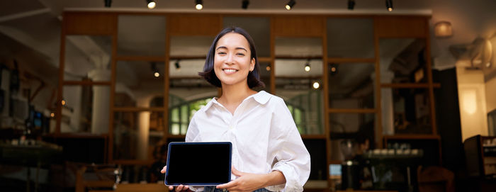 Portrait of young businesswoman using digital tablet