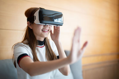 Girl using virtual reality headset at home