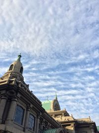 Low angle view of church against cloudy sky