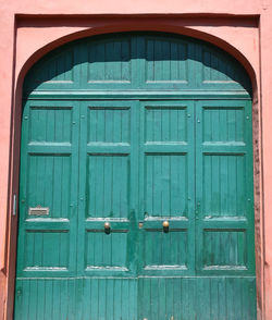 Old vintage pastel green doorway and pastel pink wall. ravenna, italy.