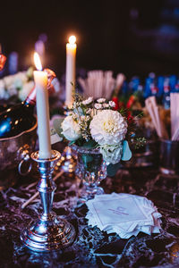 Close-up of illuminated candles on table