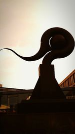 Silhouette sculpture against sky