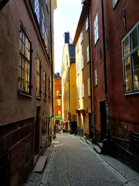 Narrow street amidst buildings in city