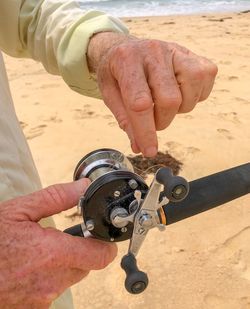 Close-up of man holding sand