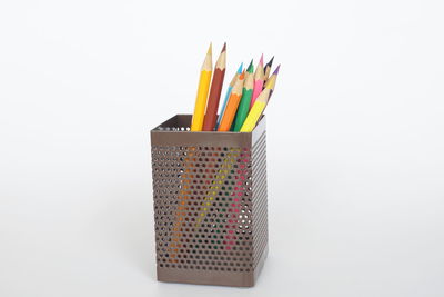 Close-up of multi colored pencils against white background