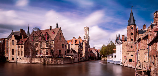 Panoramic view of river amidst buildings against sky in city