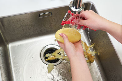 Midsection of woman holding ice cream at home