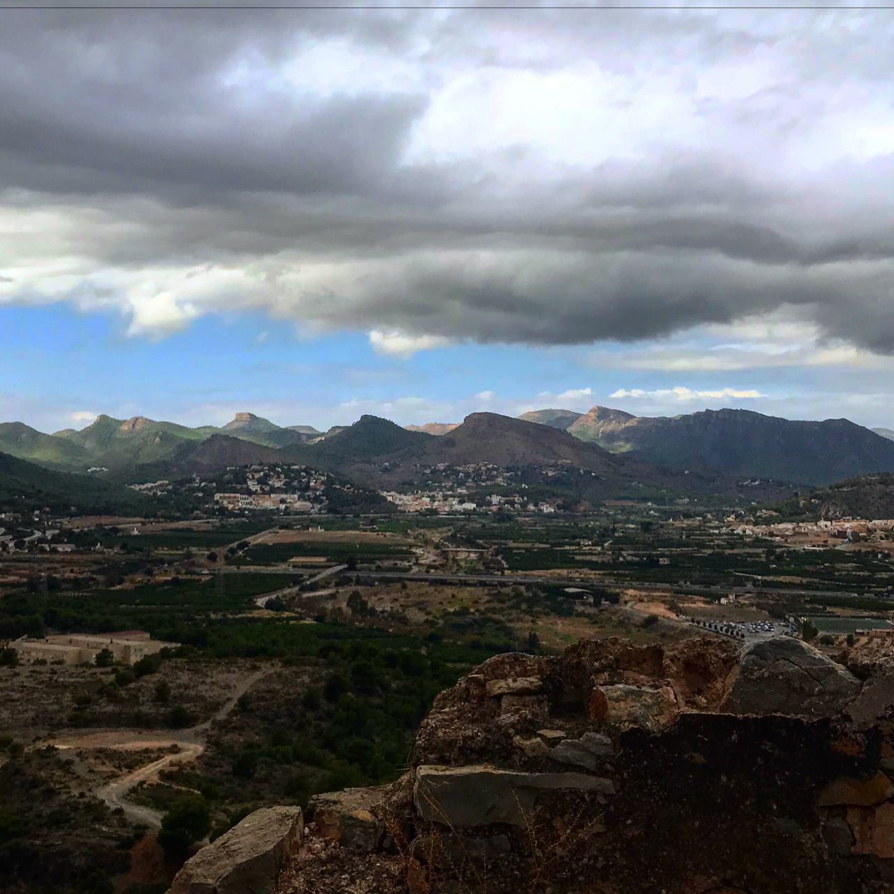 mountain, sky, cloud - sky, beauty in nature, mountain range, no people, built structure, nature, landscape, scenics, day, outdoors, architecture, building exterior, cityscape