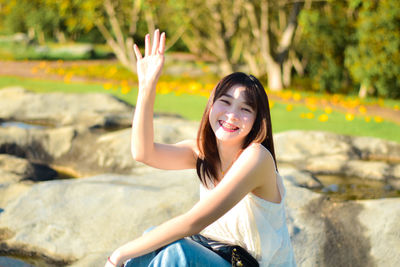 Young woman sitting on rock