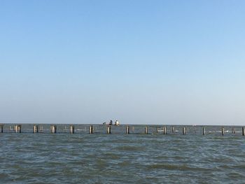 Pier over sea against clear sky