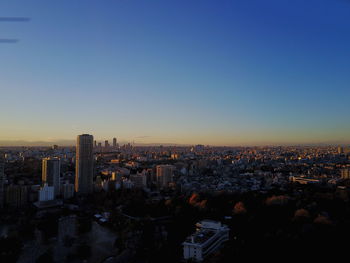 View of cityscape against clear sky during sunset