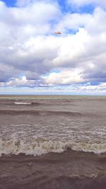 Scenic view of sea against cloudy sky