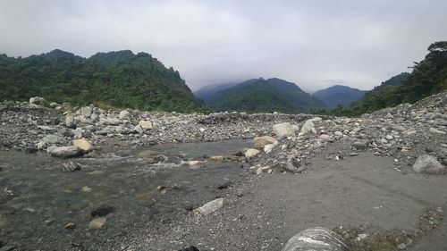 Scenic view of rocks on land against sky