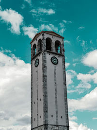 Low angle view of elbasan castle clock tower against cloudy sky