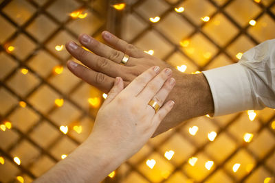 Close-up of hand holding illuminated lighting equipment