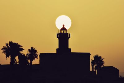 Low angle view of silhouette building against sky during sunset