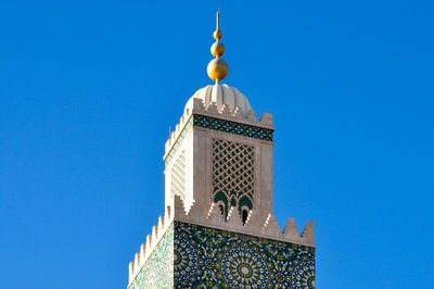 High section of mosque against clear blue sky